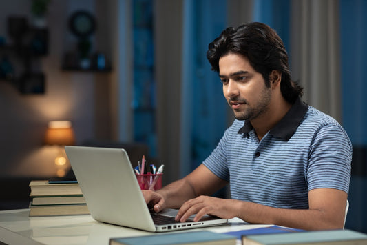 Man studying on his computer to pass his ICC contractor exam
