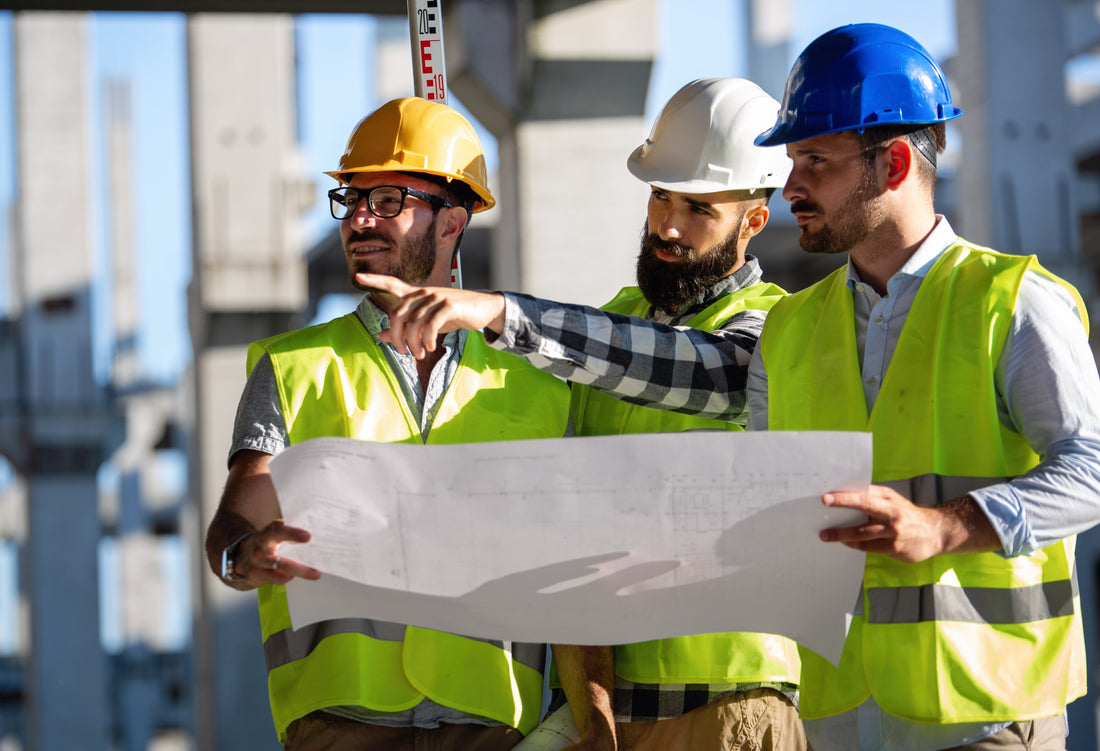 team of general contractors or construction contractors reviewing plans
